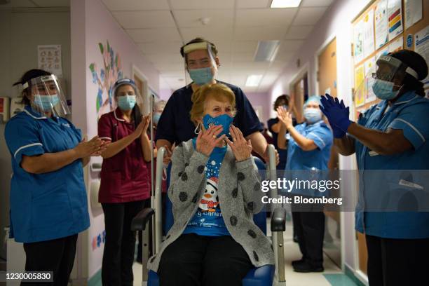 National Health Service staff applaud Margaret Keenan as she is returned to her ward after becoming the first person in the U.K. To receive the...