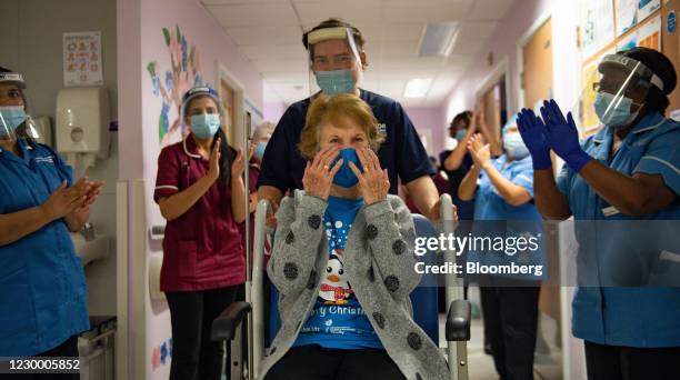 National Health Service staff applaud Margaret Keenan as she is returned to her ward after becoming the first person in the U.K. To receive the...