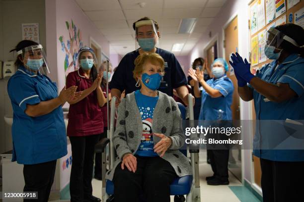 National Health Service staff applaud Margaret Keenan as she is returned to her ward after becoming the first person in the U.K. To receive the...