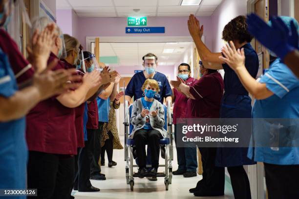 National Health Service staff applaud Margaret Keenan as she is returned to her ward after becoming the first person in the U.K. To receive the...