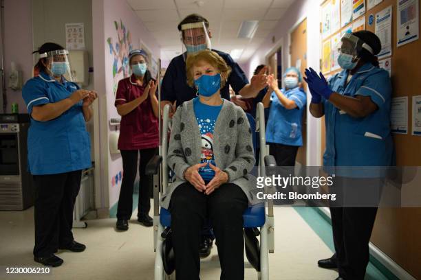 National Health Service staff applaud Margaret Keenan as she is returned to her ward after becoming the first person in the U.K. To receive the...
