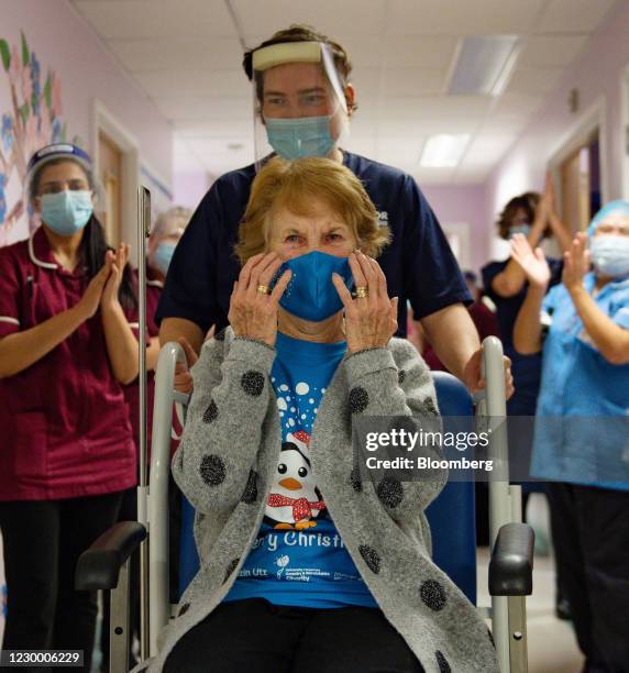 National Health Service staff applaud Margaret Keenan as she is returned to her ward after becoming the first person in the U.K. To receive the...