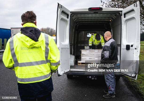 Employees of the Human Environment and Transport Inspectorate conduct a road check along the A12 near Babberich in the municipality of Zevenaar, on...