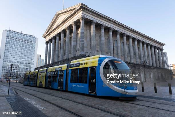 Tram passing Town Hall in the City Centre on 26th November 2020 in Birmingham, United Kingdom. The Midland Metro is a light-rail tram line in the...