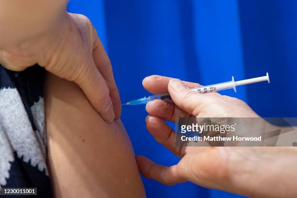 Close-up as a vaccination is given at Cardiff and Vale Therapy Centre on December 8, 2020 in Cardiff, Wales. More than 50 hospitals across United...