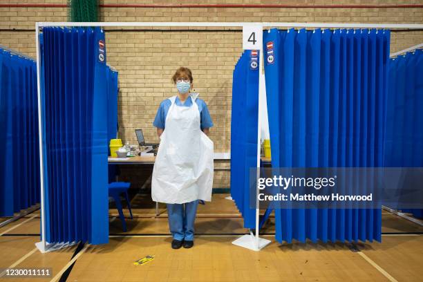 Vaccinator poses for a photograph in a booth at Cardiff and Vale Therapy Centre on December 8, 2020 in Cardiff, Wales. More than 50 hospitals across...