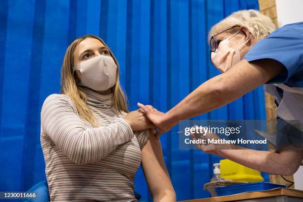 Woman is given a Pfizer-BioNTech Covid-19 vaccine at Cardiff and Vale Therapy Centre on December 8, 2020 in Cardiff, Wales. Wales joined the other UK...