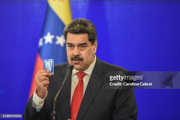 Nicolas Maduro President of Venezuela speaks to the media to give a balance of the recent Parliamentary elections whie showing a miniature of the...