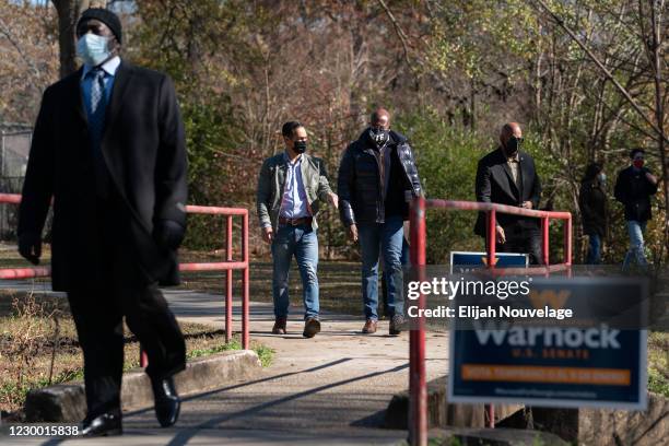 Democratic U.S. Senate candidate Raphael Warnock arrives at a campaign event with former Democratic presidential candidate Julián Castro on December...