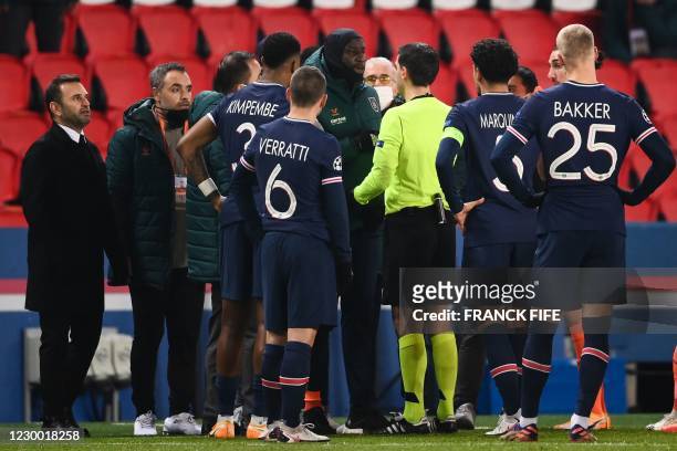 Istanbul Basaksehir's French forward Demba Ba talks to referee during the UEFA Champions League group H football match between Paris Saint-Germain...