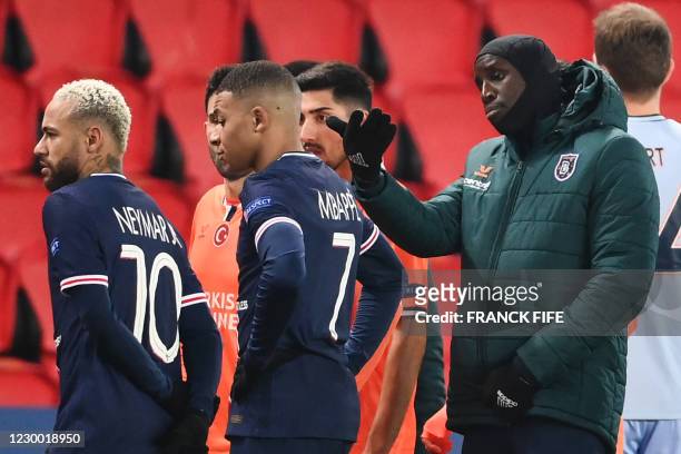 Istanbul Basaksehir's French forward Demba Ba gestures past Paris Saint-Germain's Brazilian forward Neymar and Paris Saint-Germain's French forward...