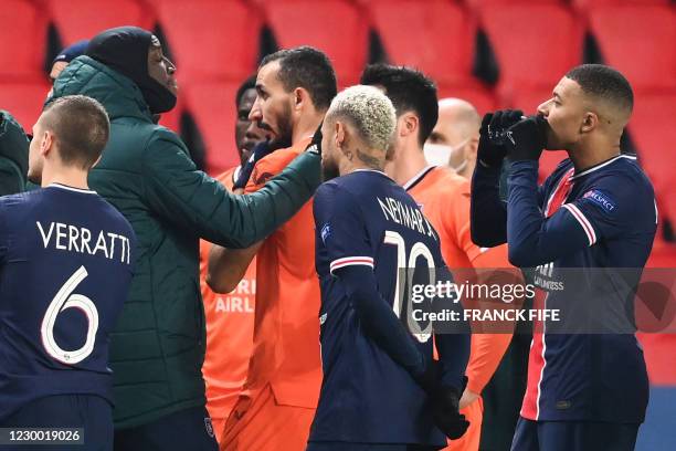 Istanbul Basaksehir's French forward Demba Ba gestures past Paris Saint-Germain's French forward Kylian Mbappe and Paris Saint-Germain's Brazilian...