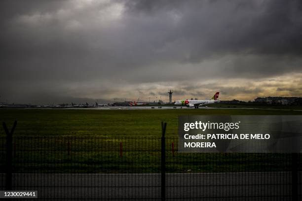 Air Portugal plane waits on the tarmac to take off at Humberto Delgado airport in Lisbon on December 9, 2020. - The Portuguese government is due to...