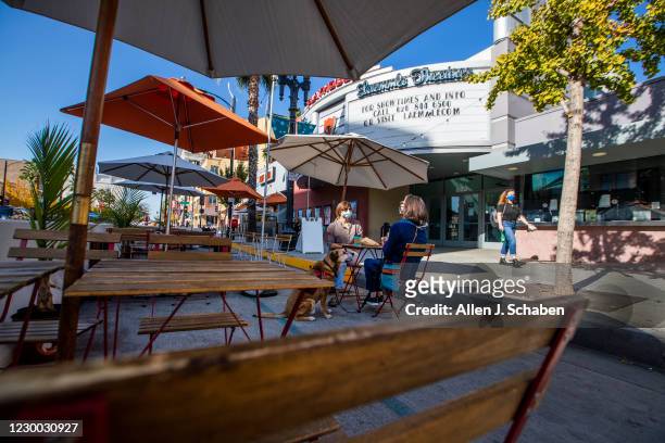 People dine with their dog in front of the closed Laemmle Theatre on Colorado Blvd. Where several businesses have closed and many struggle to stay...