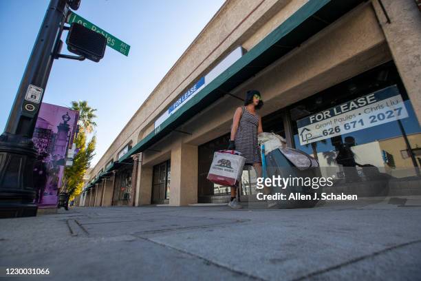 Pedestrian walks past a closed business on Colorado Blvd. Where several businesses have closed and many struggle to stay open during California...
