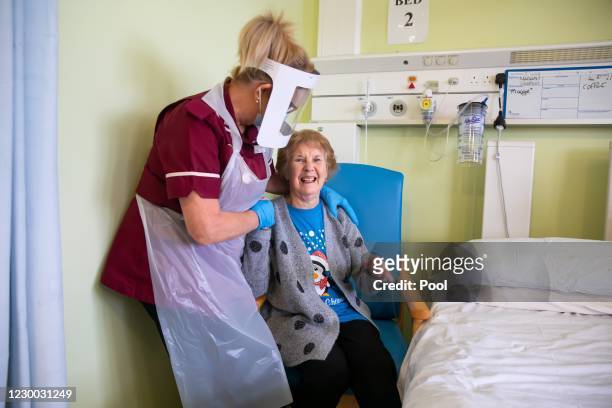 Margaret Keenan the first patient in the United Kingdom to receive the Pfizer/BioNtech covid-19 vaccine, speaks with Healthcare assistant Lorraine...