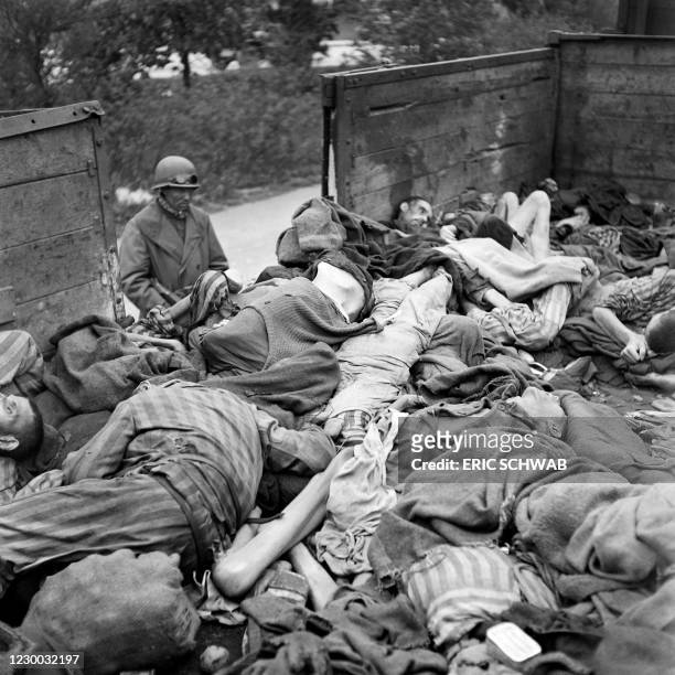 Graphic content / A soldiers looks at prisoner's dead bodies stacked in a train near Dachau concentration camp in late April or early May 1945, after...