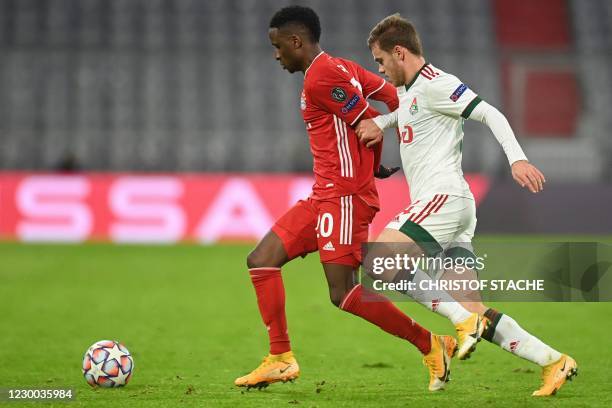 Bayern Munich's French defender Bouna Sarr and Lokomotiv Moscow's Russian midfielder Dmitri Rybchinskiy vie for the ball during the UEFA Champions...