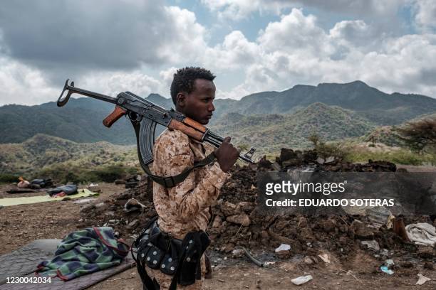 Member of the Afar Special Forces stands in front of the debris of a house in the outskirts of the village of Bisober, Tigray Region, Ethiopia, on...
