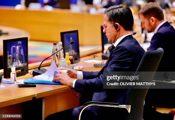 Netherlands' Prime Minister Mark Rutte watches a video as EU leaders pay tribute to late French President Valery Giscard d'Estaing prior to a round...