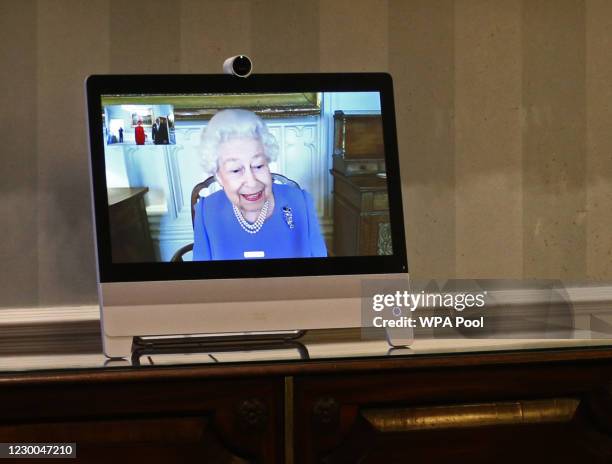 Queen Elizabeth II appears on a screen by videolink from Windsor Castle, where she is in residence, during a virtual audience to receive His...