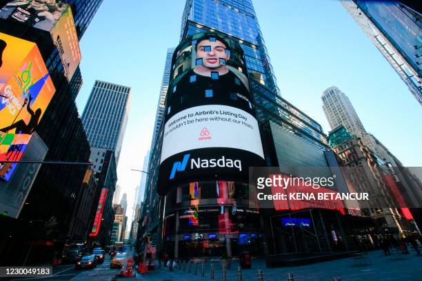 The Airbnb logo is displayed on the Nasdaq digital billboard in Times Square in New York on December 10, 2020. - Home-sharing giant Airbnb was set...
