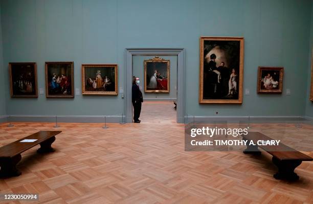 Security guard stands in the doorway during a press viewing of "A New Look at Old Masters" a newly installed gallery for European Paintings, on...