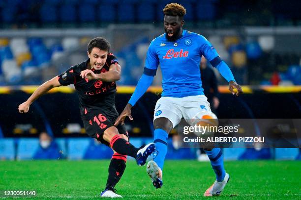 Real Sociedad's Spanish midfielder Ander Guevara shoots on goal despite Napoli's French midfielder Tiemoue Bakayoko during the UEFA Europa League...