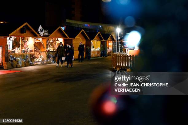 People walk in the Christmas market in Amneville-les-Thermes on December 10 the only one of the kind in the eastern France department of Moselle.