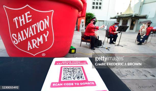 The Salvation Army band plays in the forecourt of the TCL Chinese Theater as a QR code is displayed on December 10, 2020 in Hollywood, California. -...