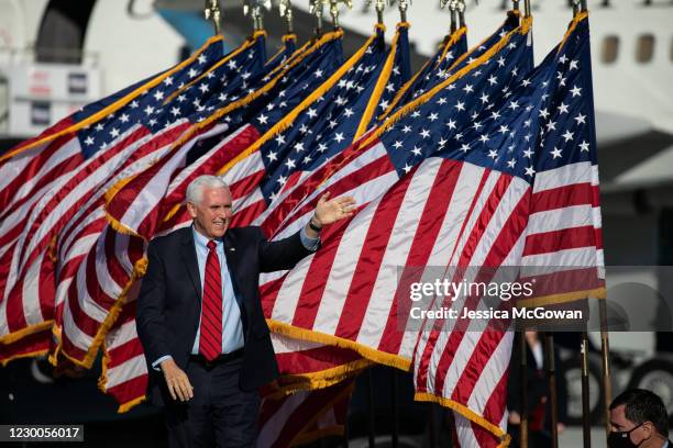 Vice President Mike Pence waves to the crowd as he arrives to a rally in support of Sen. David Purdue and Sen. Kelly Loeffler on December 10, 2020 in...