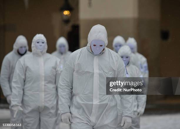 Group of activists wearing the personal protective equipment suits, during an anti-vaccine, anti-restrictions and against social conformity, march...