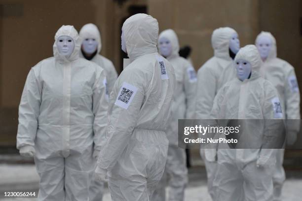 Group of activists wearing the personal protective equipment suits, during an anti-vaccine, anti-restrictions and against social conformity march...