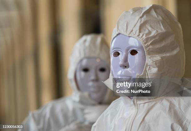 Group of activists wearing the personal protective equipment suits, during an anti-vaccine, anti-restrictions and against social conformity walks...