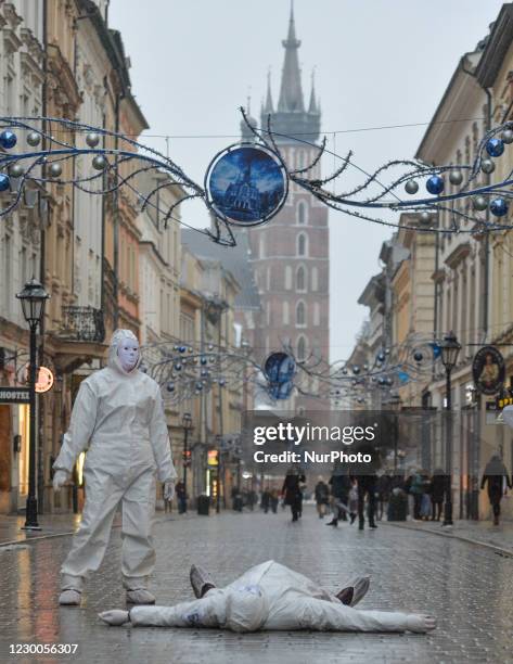 Group of activists wearing the personal protective equipment suits, during an anti-vaccine, anti-restrictions and against social conformity, march...