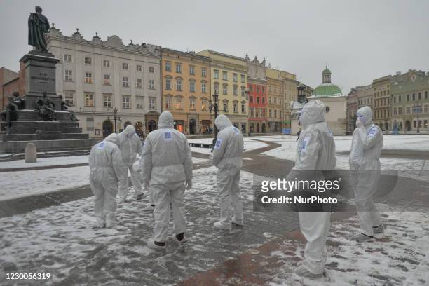 Group of activists wearing the personal protective equipment suits, during an anti-vaccine, anti-restrictions and against social conformity march...