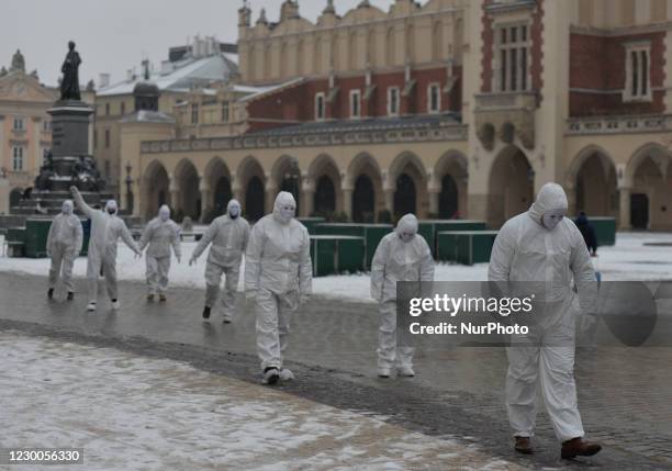 Group of activists wearing the personal protective equipment suits, during an anti-vaccine, anti-restrictions and against social conformity, march...