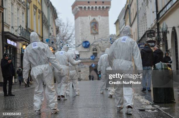 Group of activists wearing the personal protective equipment suits, during an anti-vaccine, anti-restrictions and against social conformity, march...