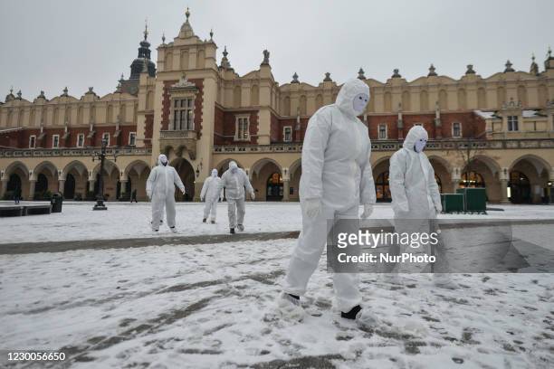 Group of activists wearing the personal protective equipment suits, during an anti-vaccine, anti-restrictions and against social conformity, march...