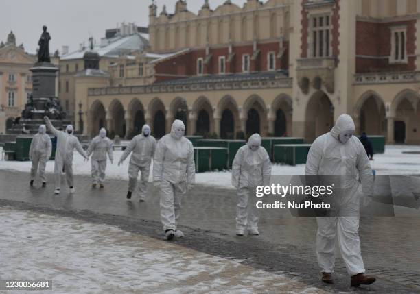 Group of activists wearing the personal protective equipment suits, during an anti-vaccine, anti-restrictions and against social conformity, march...