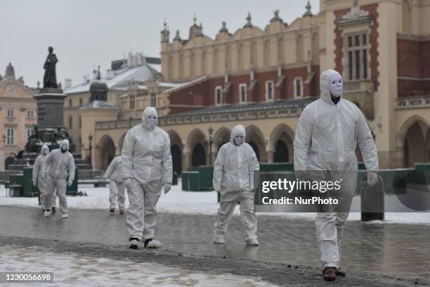 Group of activists wearing the personal protective equipment suits, during an anti-vaccine, anti-restrictions and against social conformity, march...