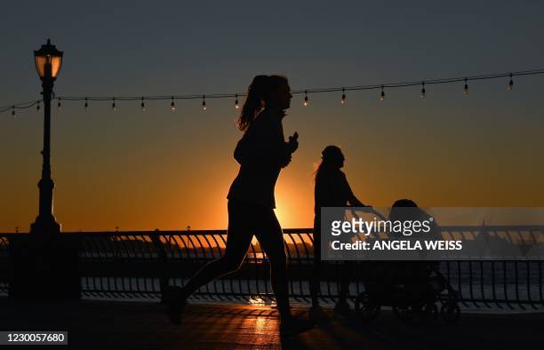 People exercise during sunset amid the Coronavirus pandemic on December 10, 2020 in New York City. - An expert committee convened by the US Food and...