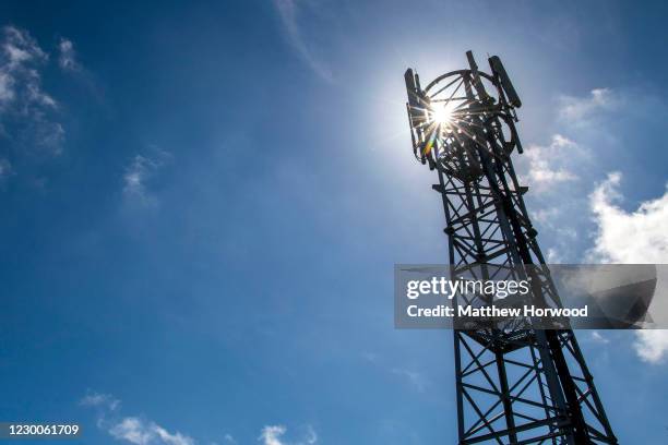 Mobile phone mast silhouetted against a blue sky on May 24, 2020 in Cardiff, United Kingdom. There have been isolated cases of 5G phone masts being...