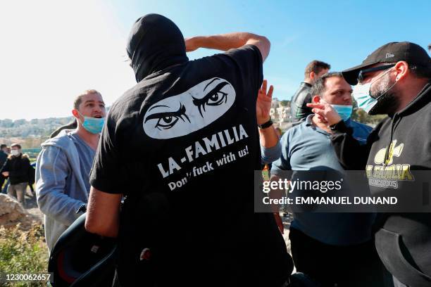 Members of "La Familia", a far-right fan group of the Israeli Beitar Jerusalem football club, confront supporters of the purchase during the club's...