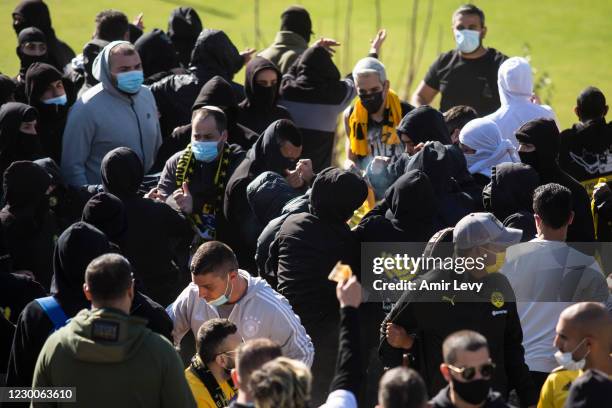 Fans of Beitar Jerusalem Football Club 'La Familia' clash with other team fans during a training session on December 11, 2020 in Jerusalem, Israel....