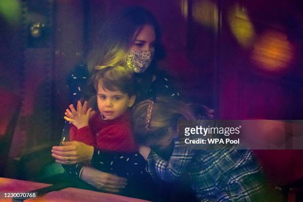 Catherine, Duchess of Cambridge, Prince Louis and Princess Charlotte attend a special pantomime performance at London's Palladium Theatre, hosted by...
