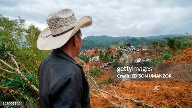 Local man looks at damaged homes after the passage of Hurricanes Eta and Iota in Proteccion, Santa Barbara department, Honduras, on December 11, 2020.