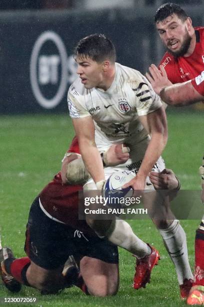 Toulouse's French scrum-half Antoine Dupont looks to offload during the European Rugby Champions Cup rugby union Group B match between Ulster and...