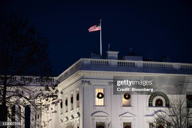 The White House at night in Washington, D.C., U.S., on Friday, Dec. 11, 2020. Bipartisan talks on a nearly trillion-dollar pandemic relief bill in...
