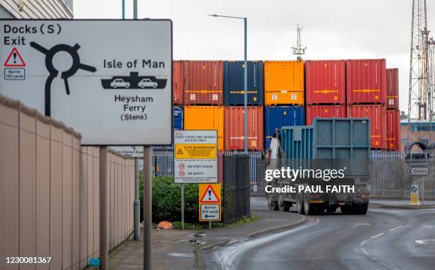 Lorry passes stacked containers in the Belfast Harbour and docks area in Northern Ireland on December 10, 2020. - The port is Northern Ireland's main...